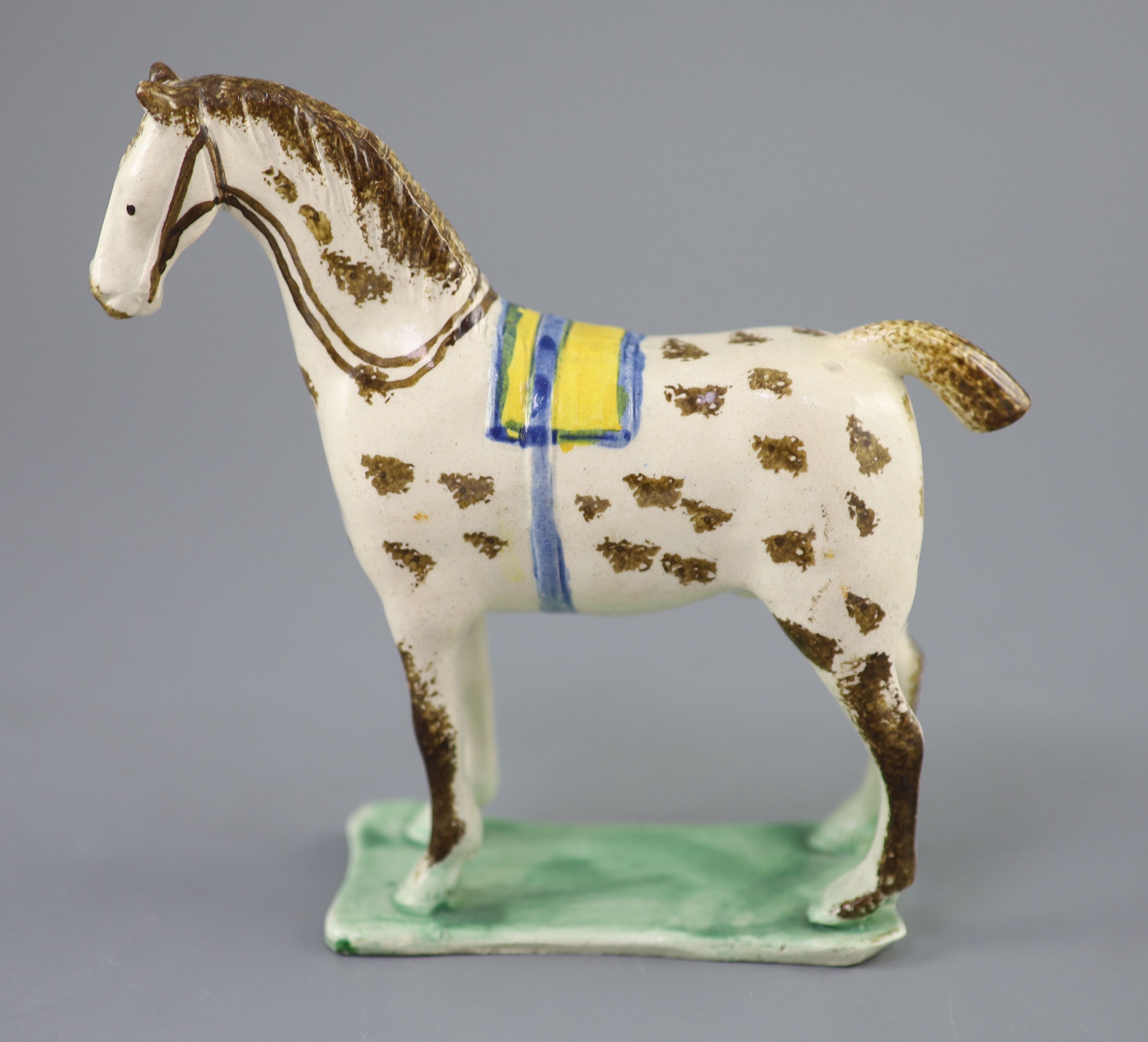 Attributed to St. Anthony Pottery, Newcastle, a pearlware figure of a racehorse with yellow saddle, c.1800-20, 15cm high